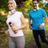 Two adults running outside in Louisiana heat while learning hydration and heat safety tips from MOPE Clinic in Metairie