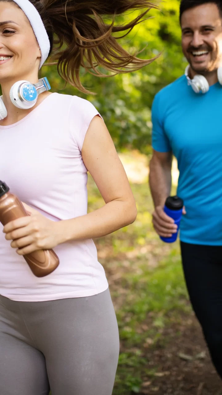 Two adults running outside in Louisiana heat while learning hydration and heat safety tips from MOPE Clinic in Metairie